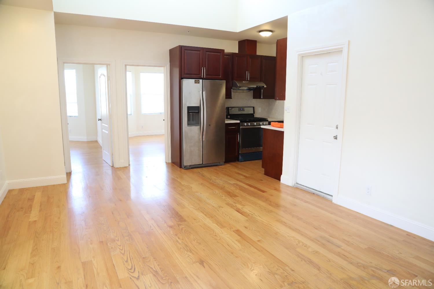 2726 San Bruno Avenue, Unit 2724 San Francisco, CA 94134 - Photo 4 of 13 a kitchen with stainless steel appliances a refrigerator and a stove