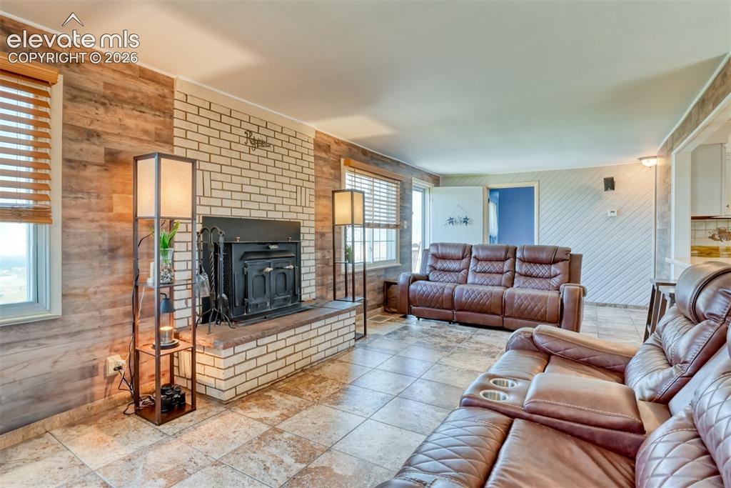 10970 Garrett Road Peyton, CO 80831 - Photo 9 of 50 a living room with furniture and a fireplace