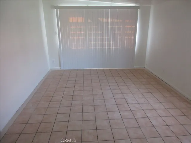 a view of an empty room and a window