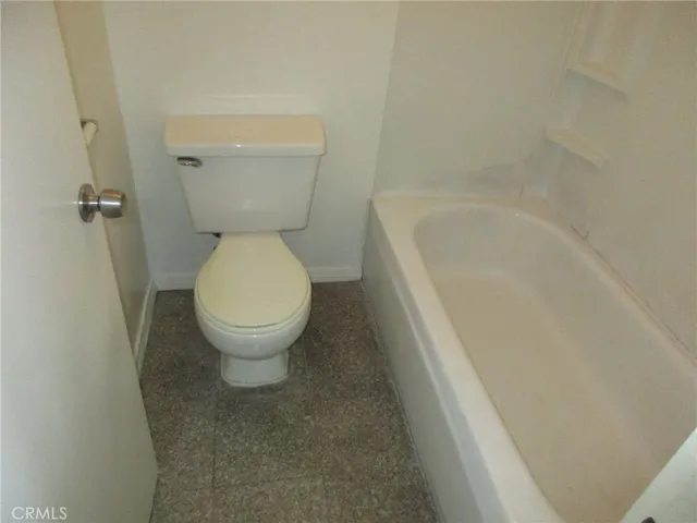 a bathroom with a toilet and a bathtub