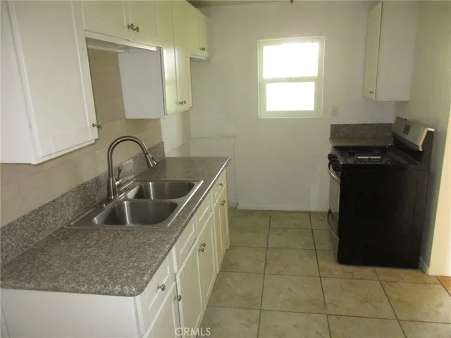 a kitchen with a sink and a refrigerator