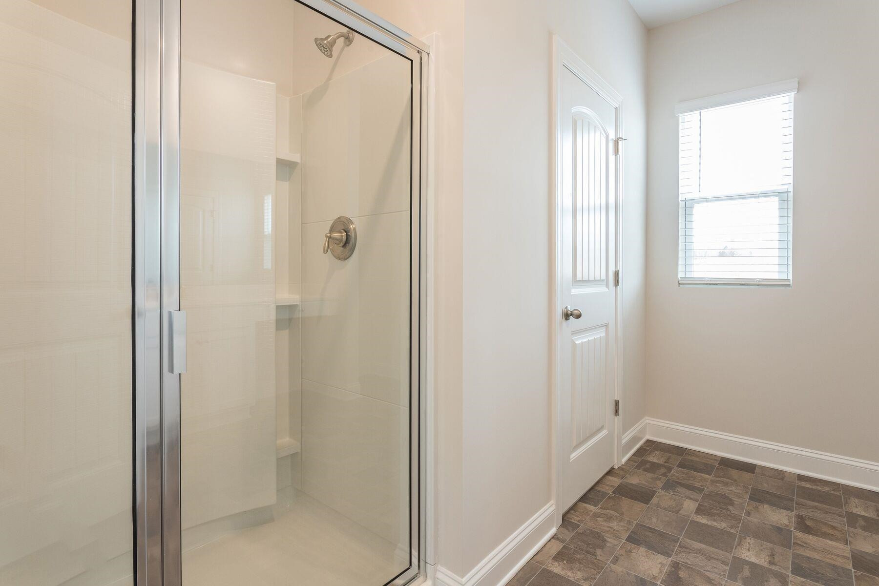 40 Symmetry Loop Youngsville, NC 27596 - Photo 11 of 17 a bathroom with a shower and a glass door