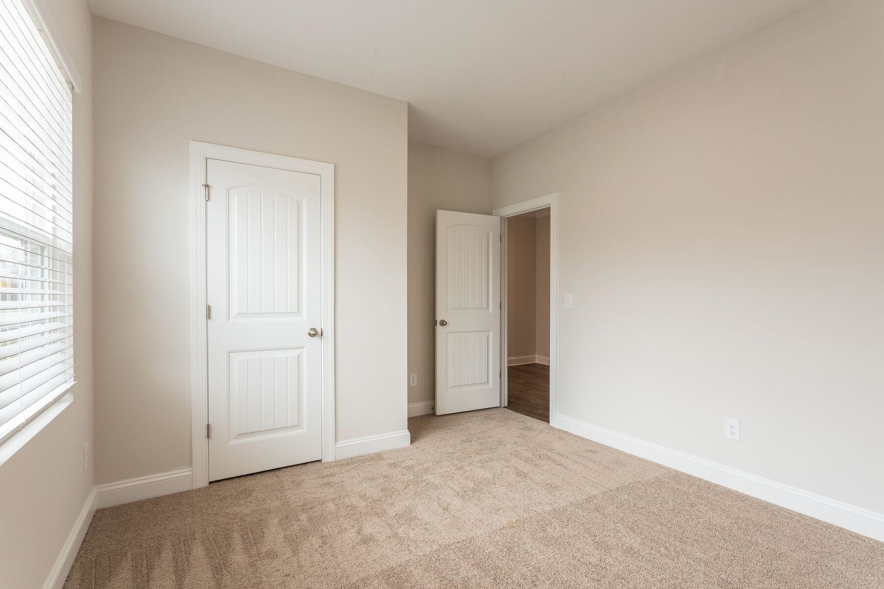 40 Symmetry Loop Youngsville, NC 27596 - Photo 14 of 17 an empty room with windows and closet