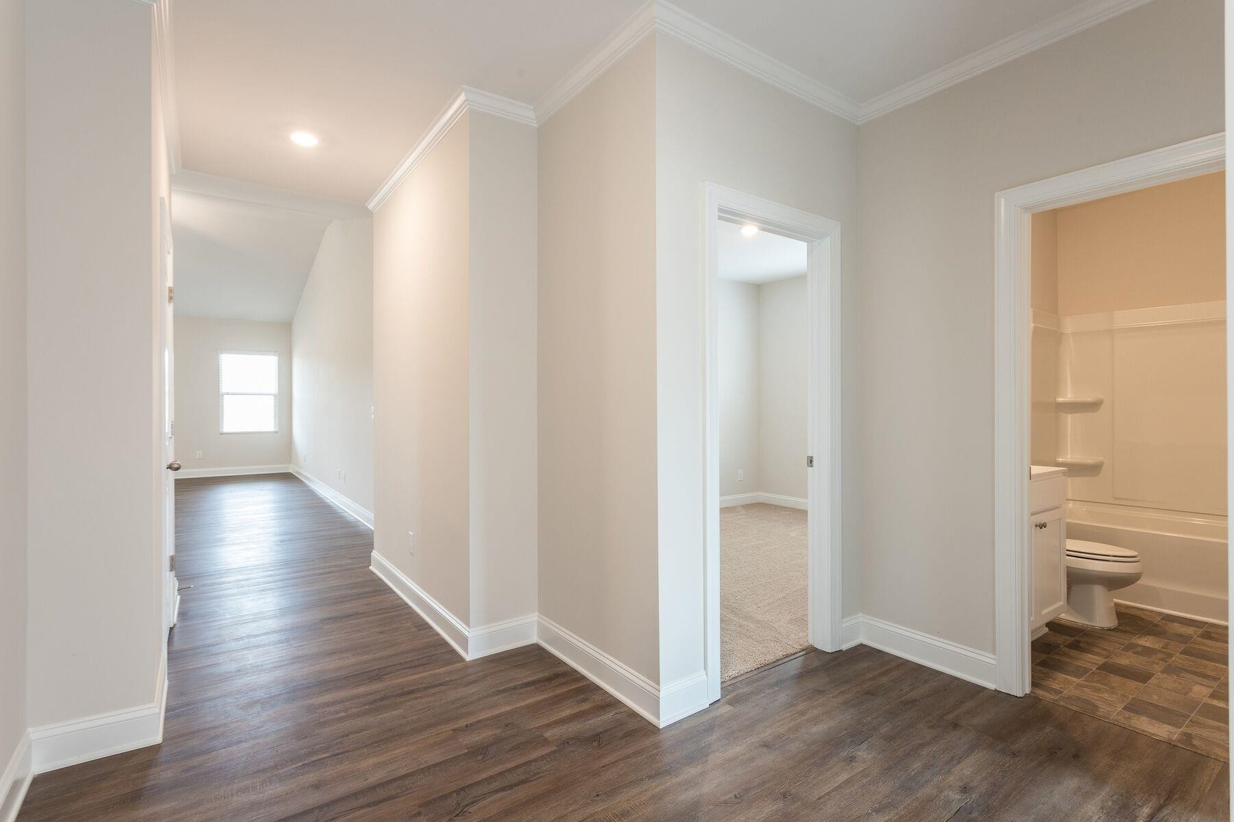 40 Symmetry Loop Youngsville, NC 27596 - Photo 2 of 17 a view of a hallway with wooden floor and a bathroom