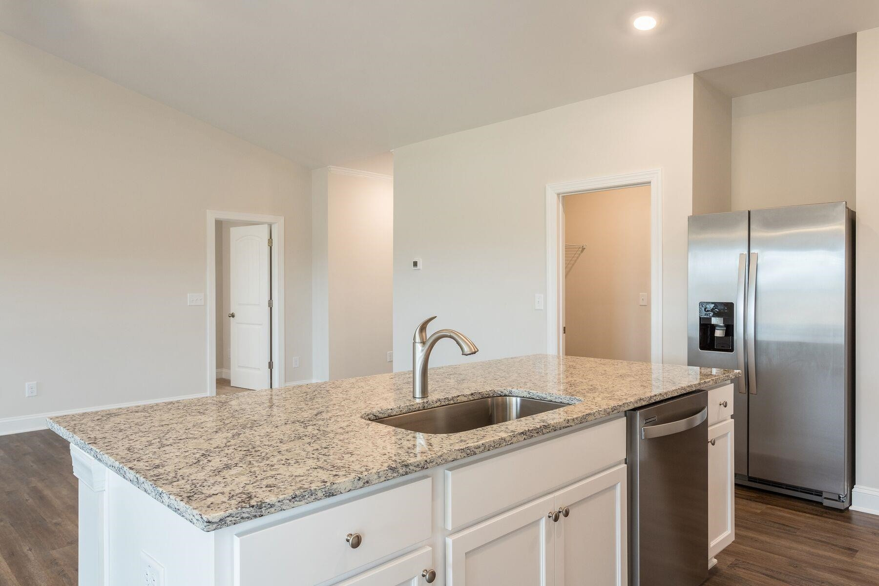 40 Symmetry Loop Youngsville, NC 27596 - Photo 8 of 17 a kitchen with granite countertop a sink and cabinets