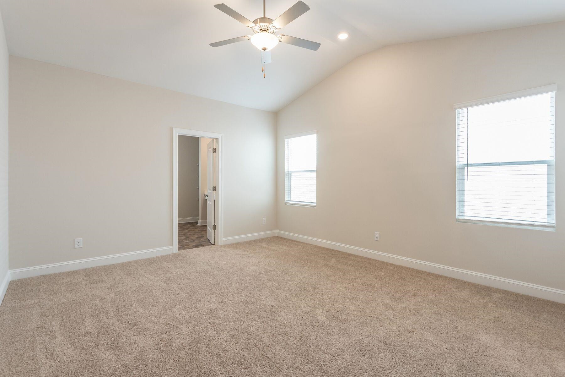 40 Symmetry Loop Youngsville, NC 27596 - Photo 9 of 17 an empty room with windows and fan