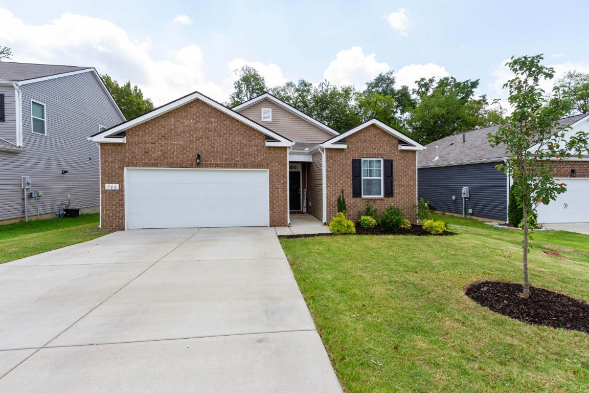 746 Prominence Road Columbia, TN 38401 - Photo 3 of 37 a front view of a house with a yard and garage