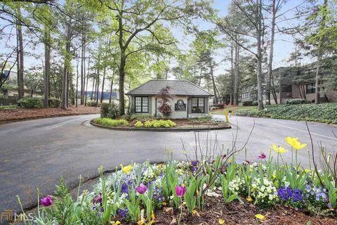 a front view of a house with a yard and fountain