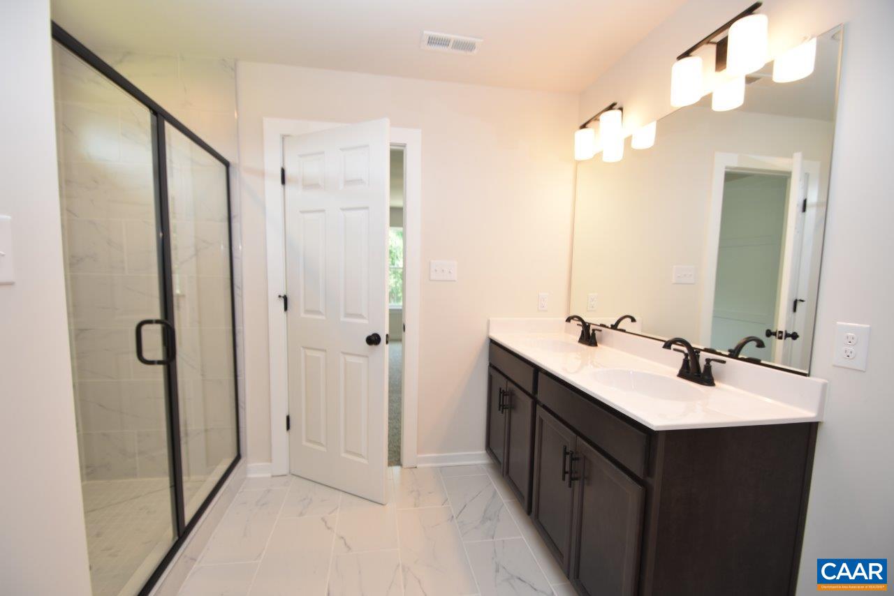 1740 Hunters Lodge Road Palmyra, VA 22963 - Photo 31 of 32 a bathroom with a double vanity sink mirror and shower