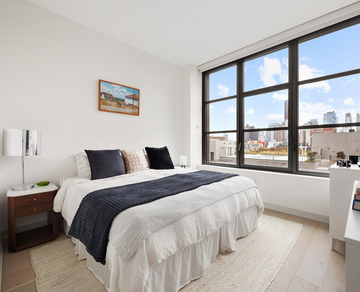 180 Front Street, Unit 9K Brooklyn, NY 11201 - Photo 6 of 15 a bedroom with a bed and a large window