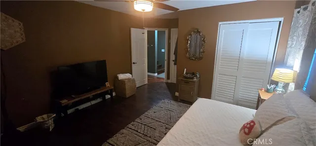 a bedroom with a bed and a double vanity sink