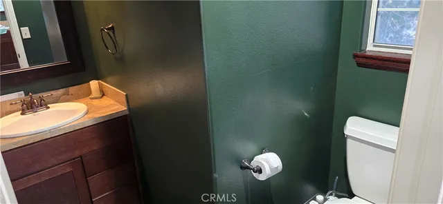 a bathroom with a sink a toilet and mirror