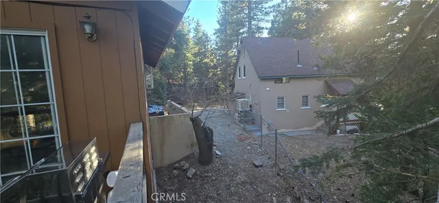 a view of a house with backyard and sitting area