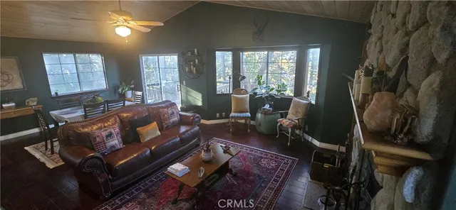 a living room with furniture and a floor to ceiling window