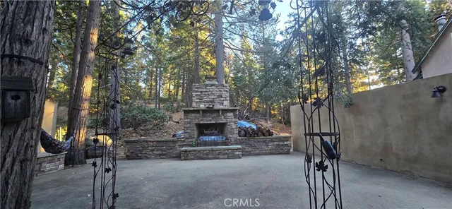 a view of a house with a tree next to a yard