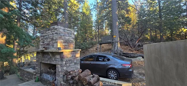 a front view of a house with cars parked on road