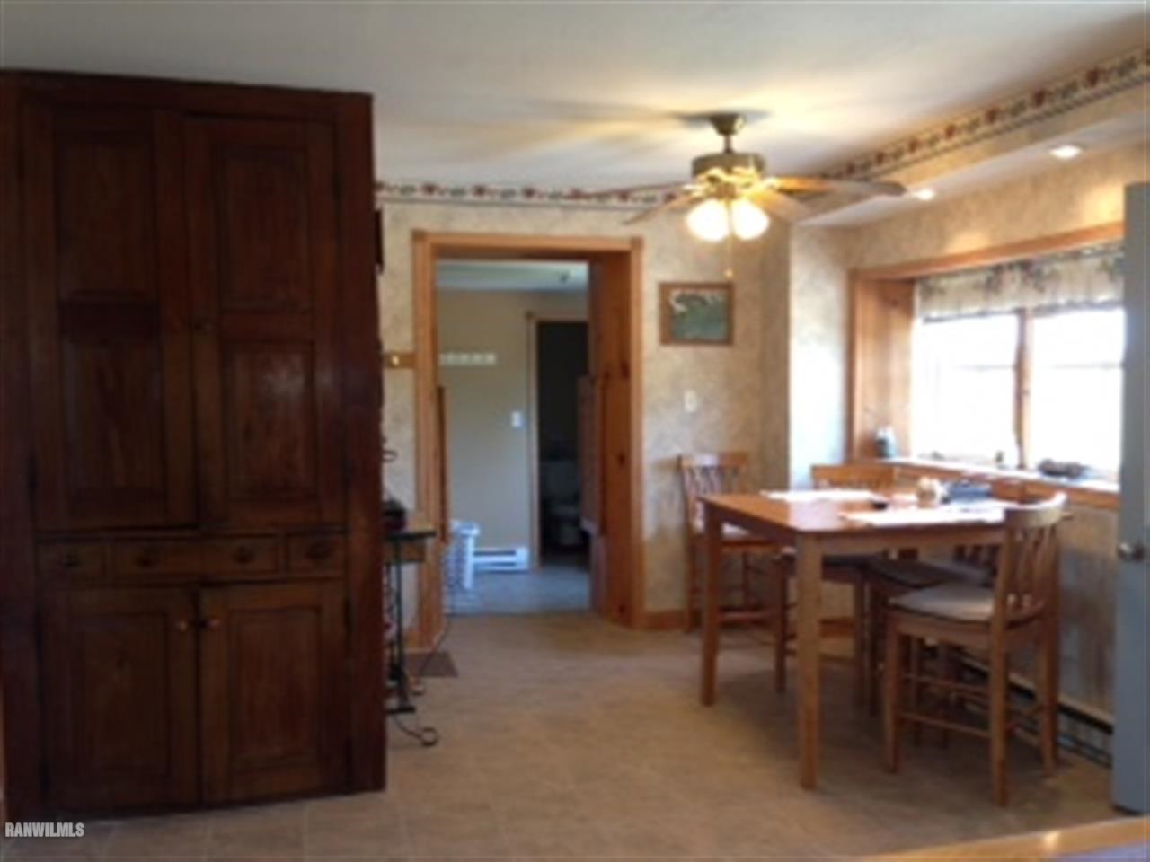 7789 North Coon Road Dakota, IL 61018 - Photo 4 of 10 a dining room with wooden floor chandelier and kitchen view