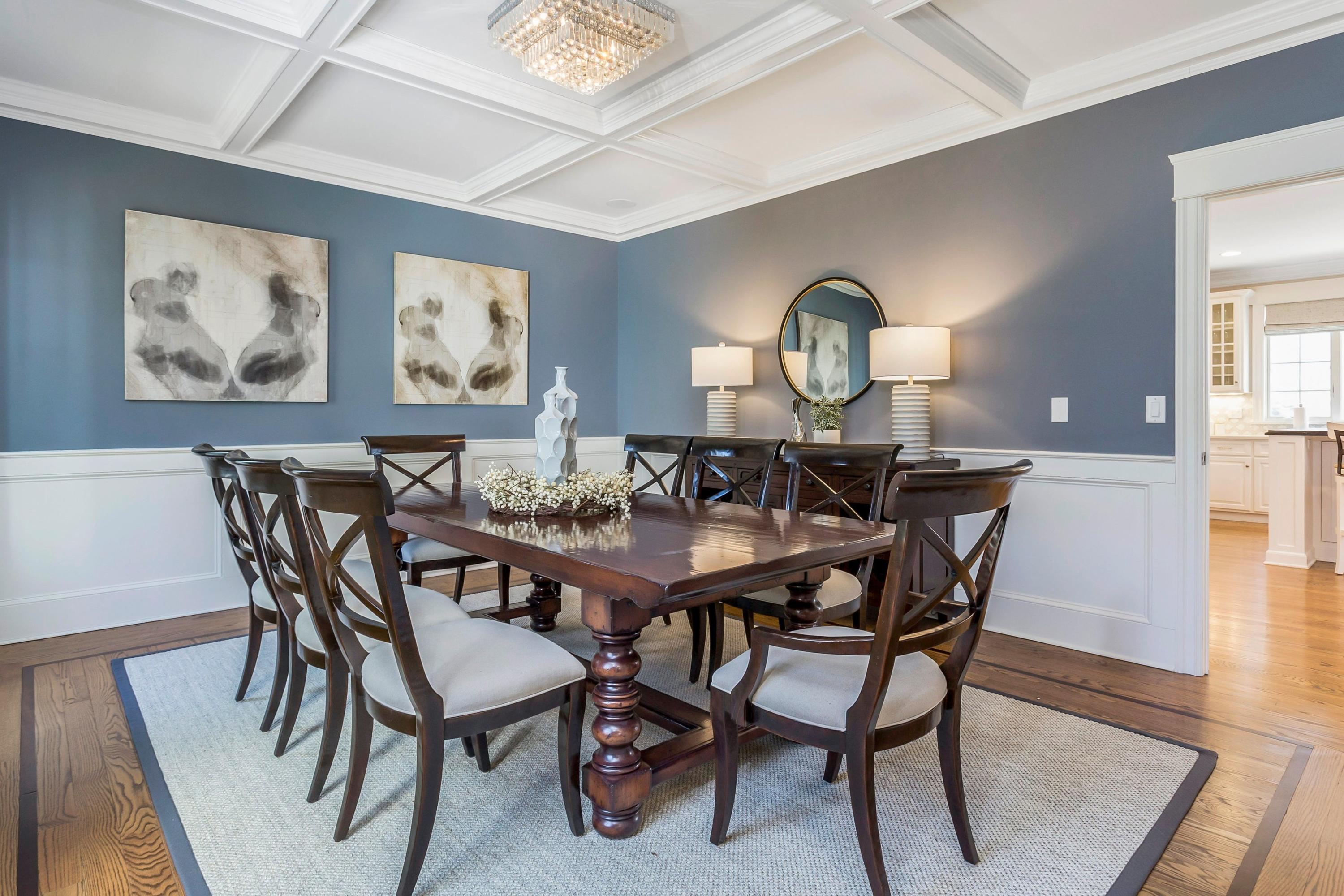 33 Briar Brae Road Darien, CT 06820 - Photo 13 of 37 a view of a dining room and livingroom with furniture wooden floor a rug and a painting