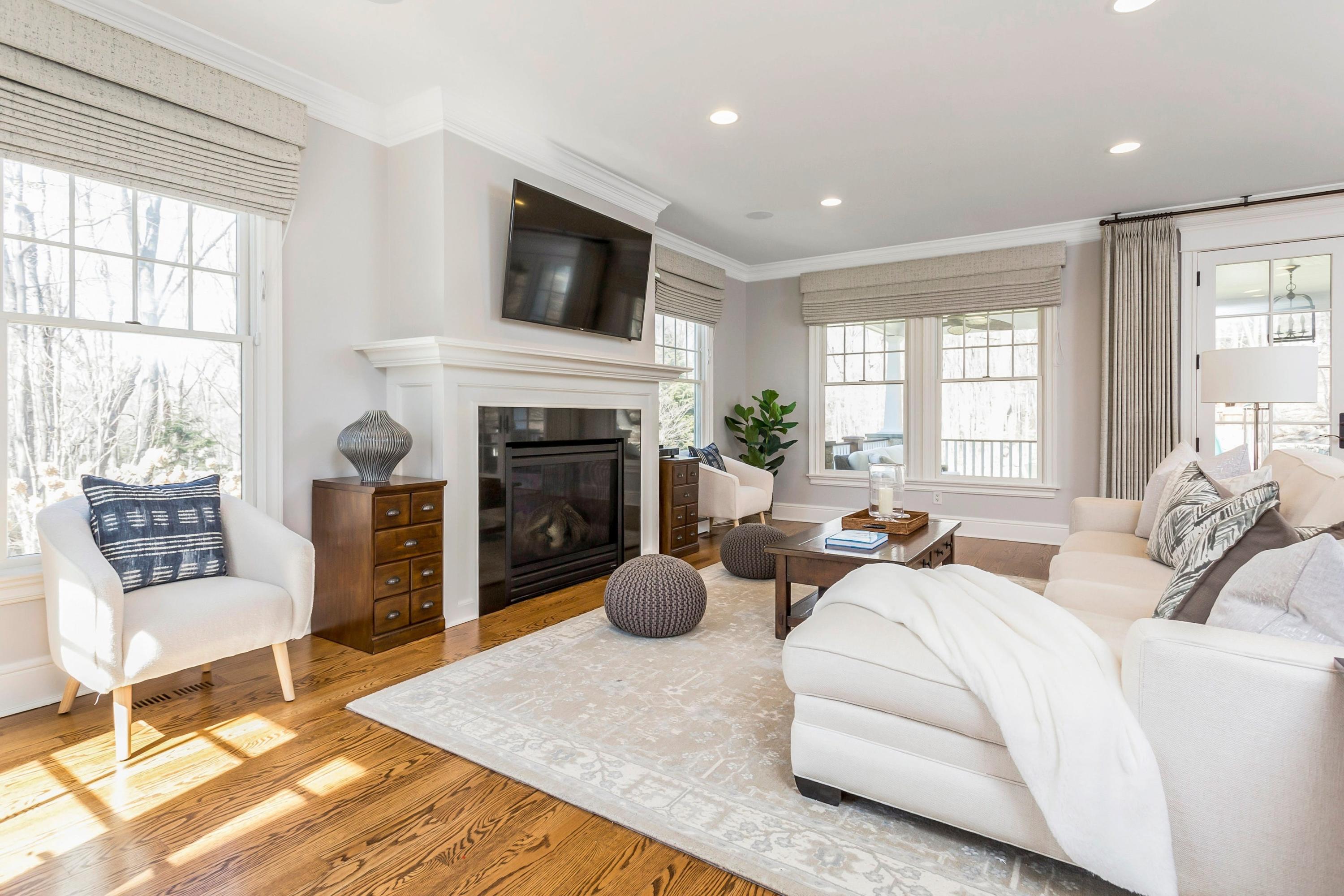 33 Briar Brae Road Darien, CT 06820 - Photo 5 of 37 a living room with fireplace furniture and a floor to ceiling window