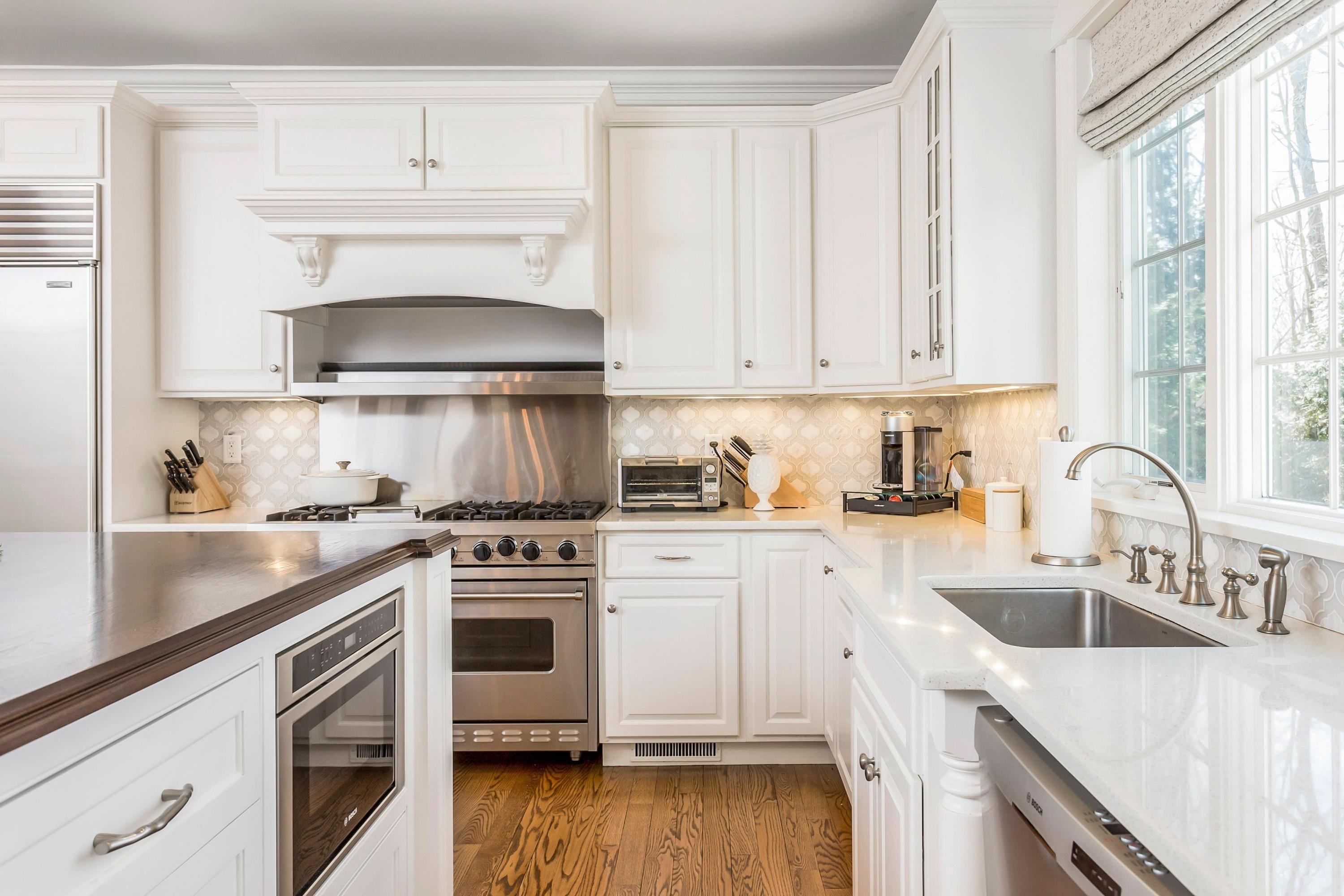 33 Briar Brae Road Darien, CT 06820 - Photo 8 of 37 a kitchen with cabinets stainless steel appliances a sink and wooden floor