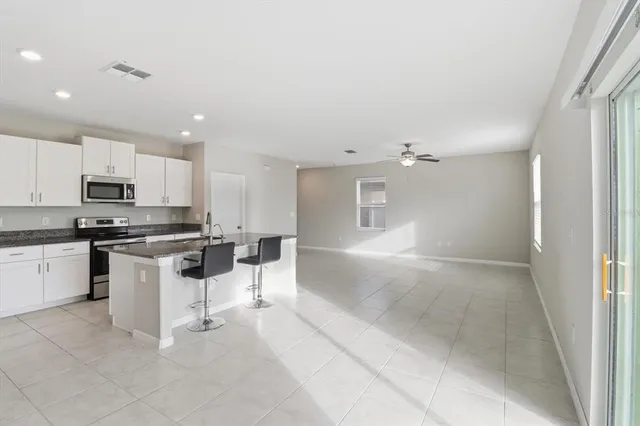 a kitchen with white cabinets and white appliances