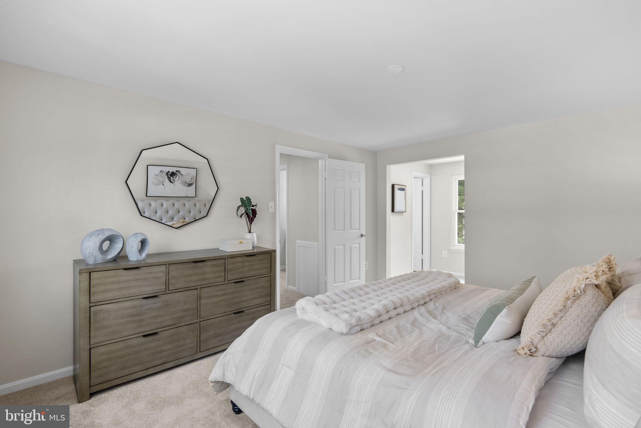 8 Seville Way Gaithersburg, MD 20878 - Photo 17 of 45 a bedroom with a bed and a chandelier
