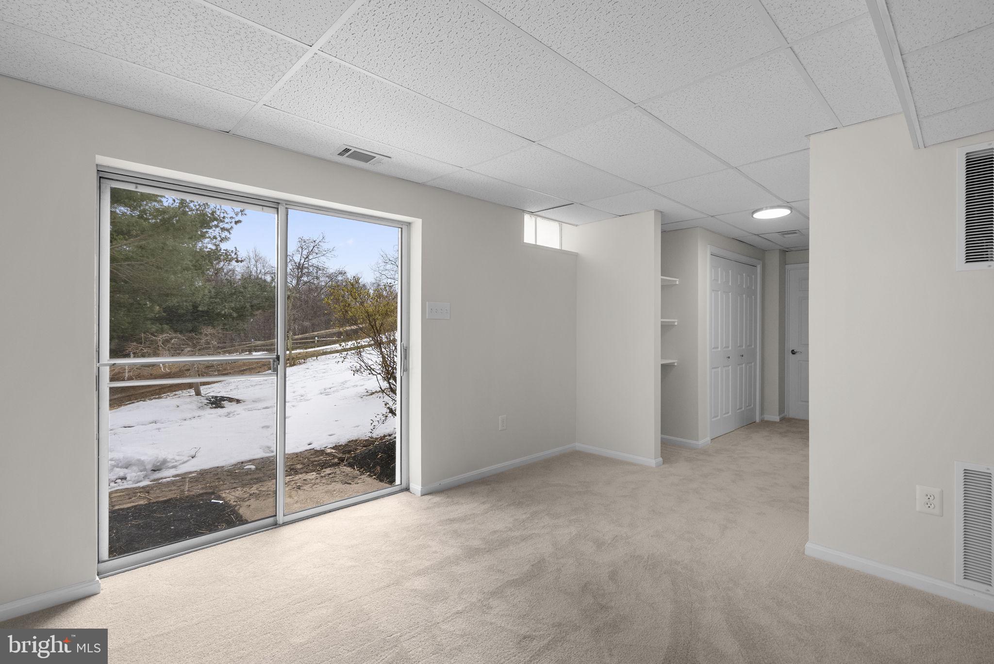 8 Seville Way Gaithersburg, MD 20878 - Photo 24 of 45 an empty room with wooden floor and windows