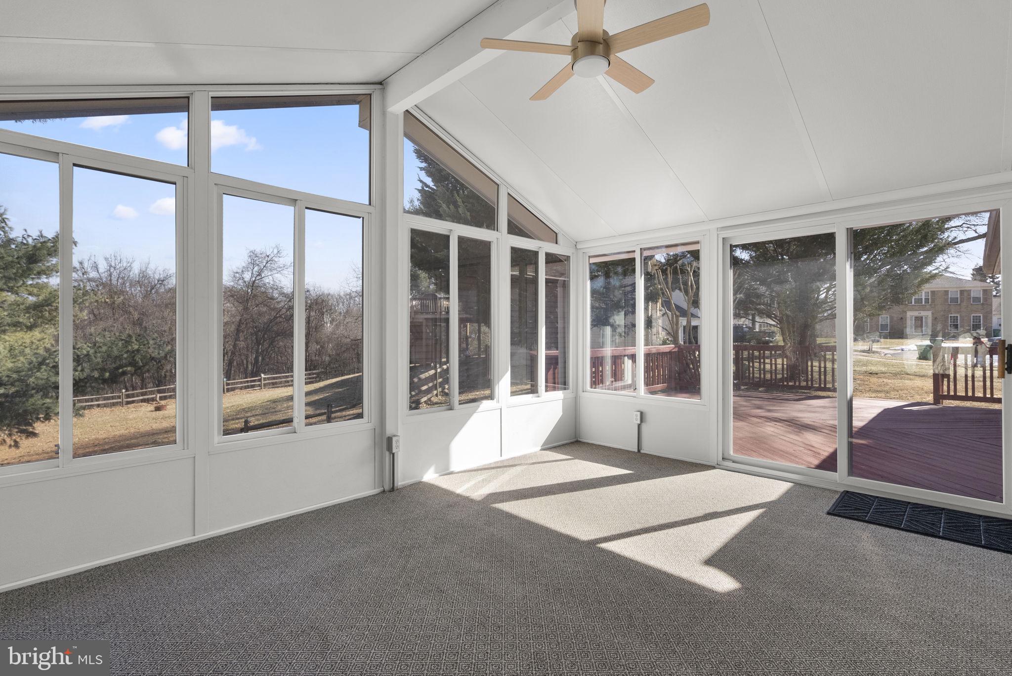 8 Seville Way Gaithersburg, MD 20878 - Photo 34 of 45 a living room with a large window and a chandelier
