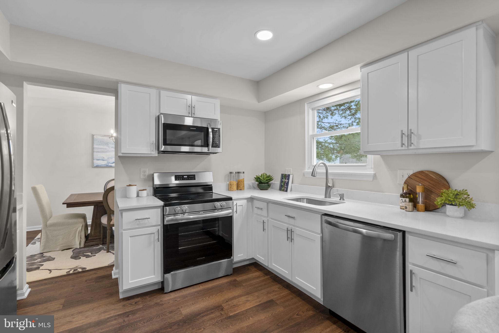 8 Seville Way Gaithersburg, MD 20878 - Photo 39 of 45 a kitchen with a sink cabinets and wooden floor