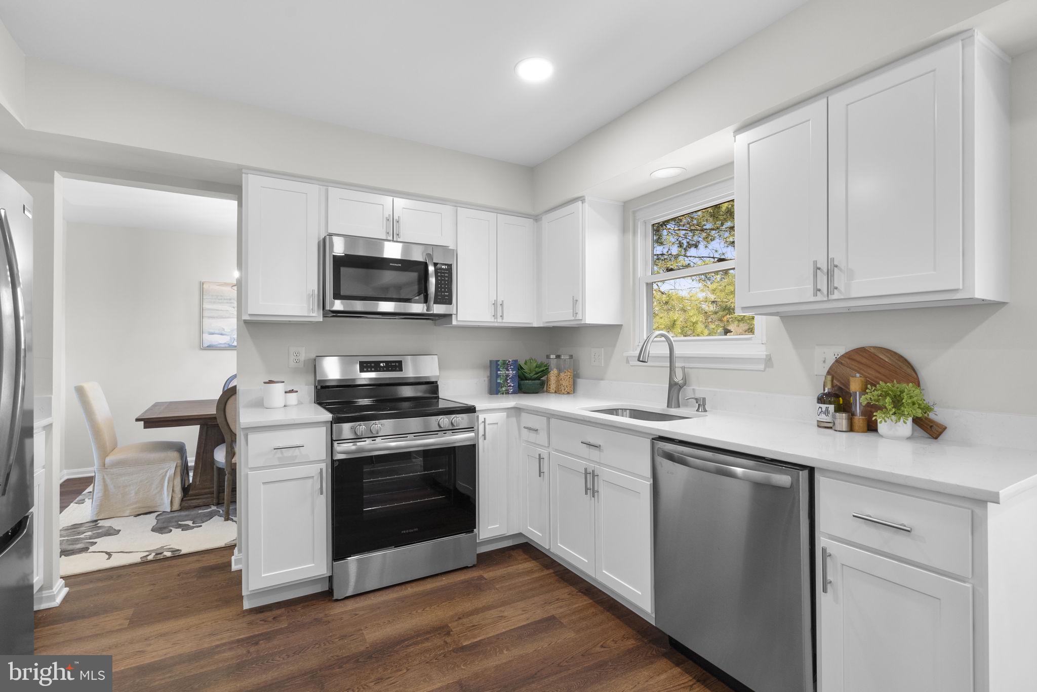 8 Seville Way Gaithersburg, MD 20878 - Photo 9 of 45 a kitchen with a sink cabinets and wooden floor