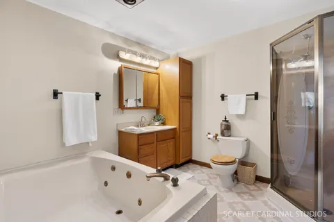 a bathroom with a tub sink toilet and mirror