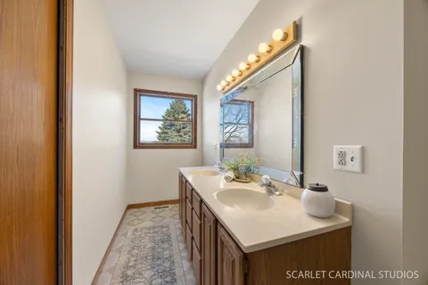 a bathroom with a sink vanity and a mirror