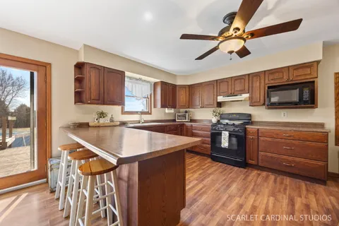 a kitchen with stainless steel appliances kitchen island granite countertop a sink and cabinets