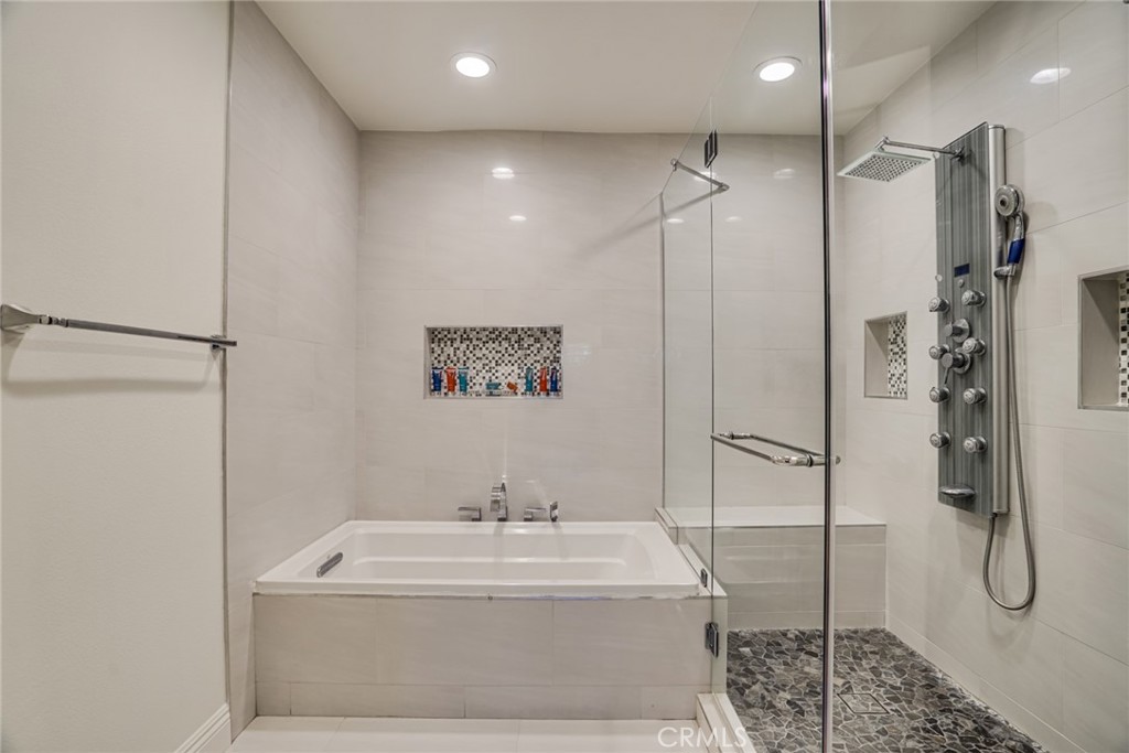 49 East Yale Loop, Unit 26 Irvine, CA 92604 - Photo 40 of 63 a bathroom with a white bath tub sitting next to shower