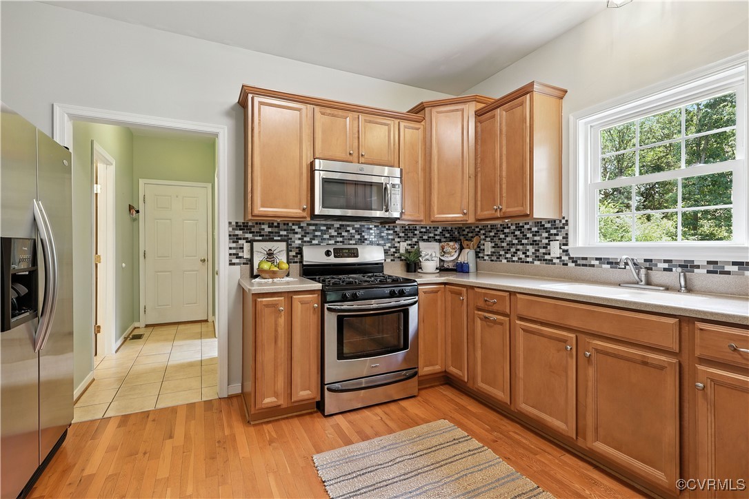 4290 Three Chopt Road Gum Spring, VA 23065 - Photo 14 of 32 a kitchen with stainless steel appliances granite countertop a stove a sink and a refrigerator