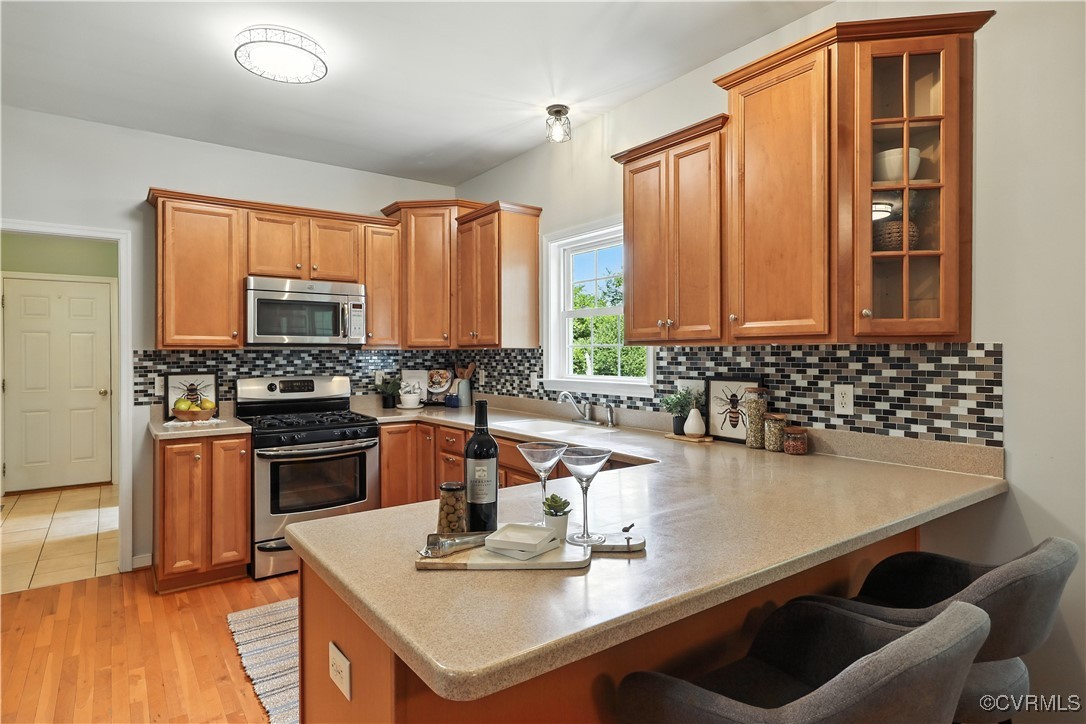 4290 Three Chopt Road Gum Spring, VA 23065 - Photo 15 of 32 a kitchen with kitchen island granite countertop a sink a stove and a microwave