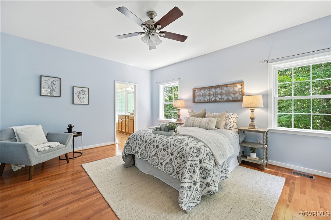 4290 Three Chopt Road Gum Spring, VA 23065 - Photo 20 of 32 a spacious bedroom with a bed a couch and a window