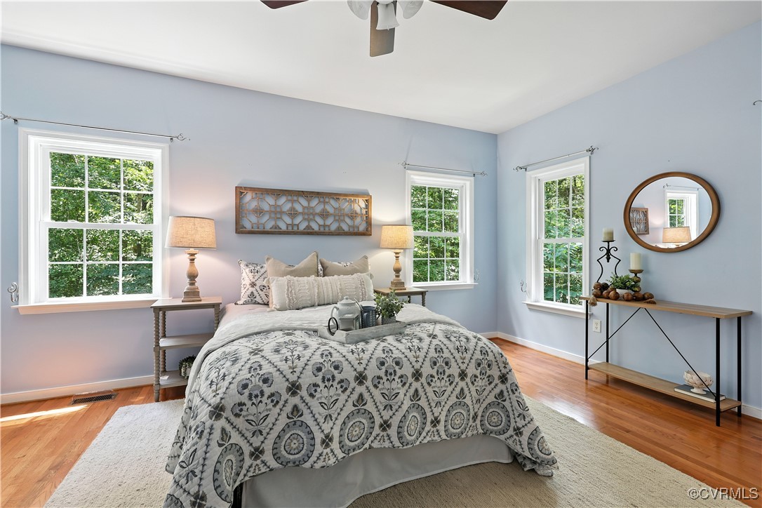 4290 Three Chopt Road Gum Spring, VA 23065 - Photo 21 of 32 a bedroom with a large bed a chandelier and a large window
