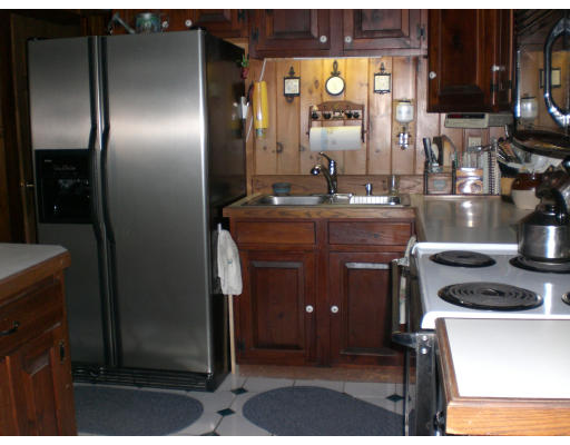 96 Rice Corner Road Brookfield, MA 01506 - Photo 11 of 23 a kitchen with a refrigerator and a sink