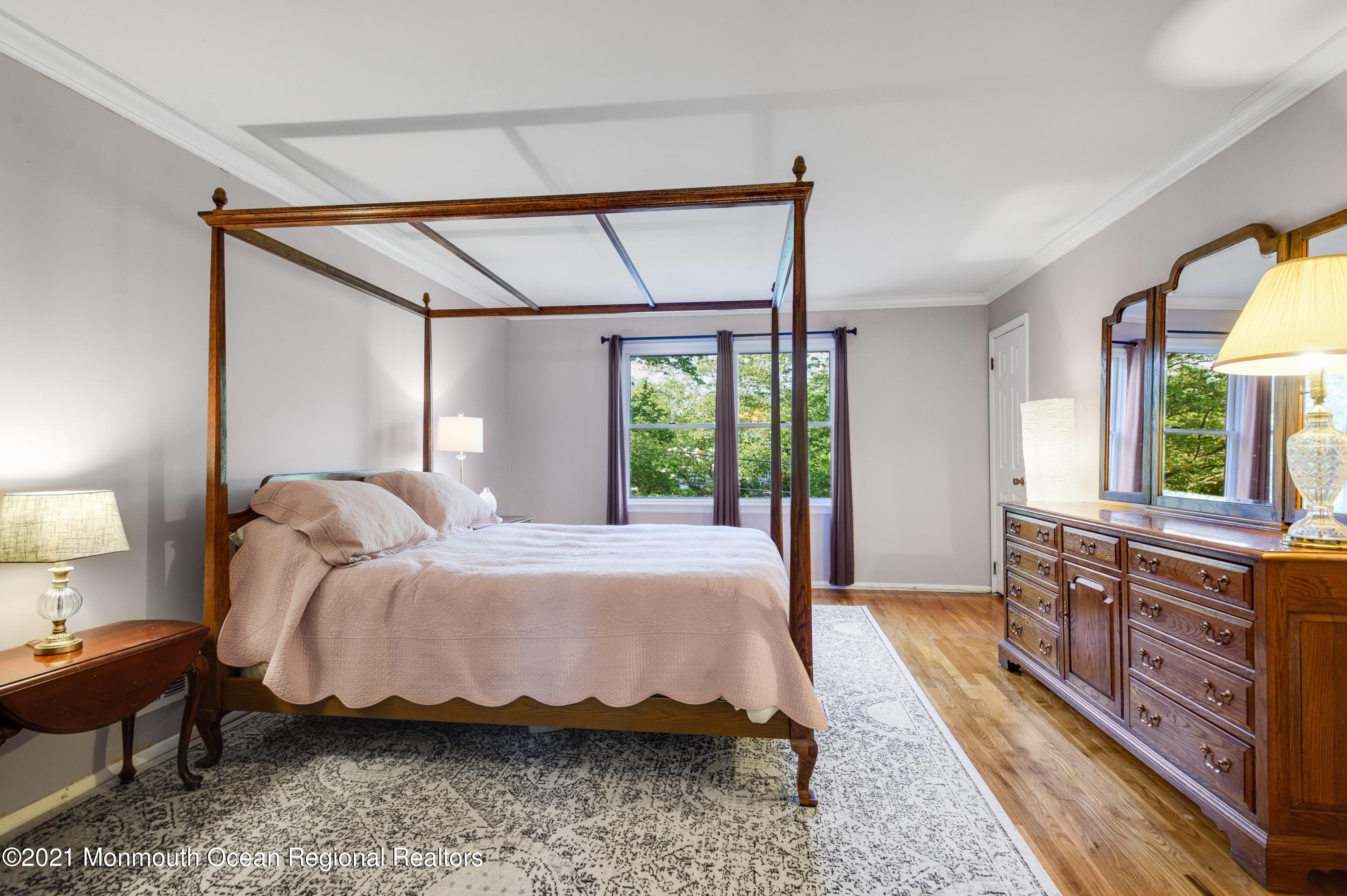 131 Bar Harbor Road Freehold, NJ 07728 - Photo 14 of 31 a bed sitting in a bedroom next to a window