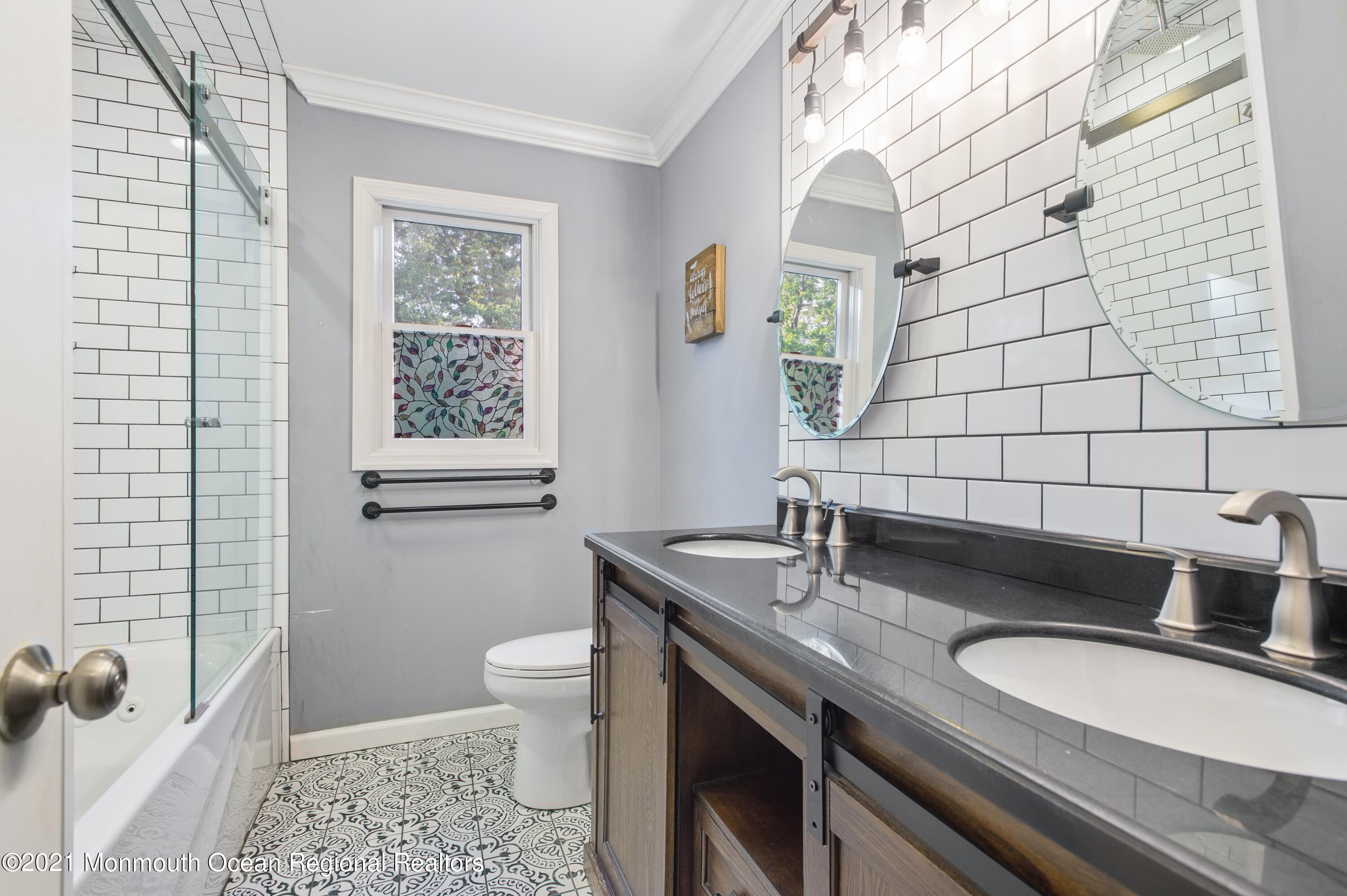 131 Bar Harbor Road Freehold, NJ 07728 - Photo 21 of 31 a bathroom with a granite countertop sink a toilet a mirror and shower