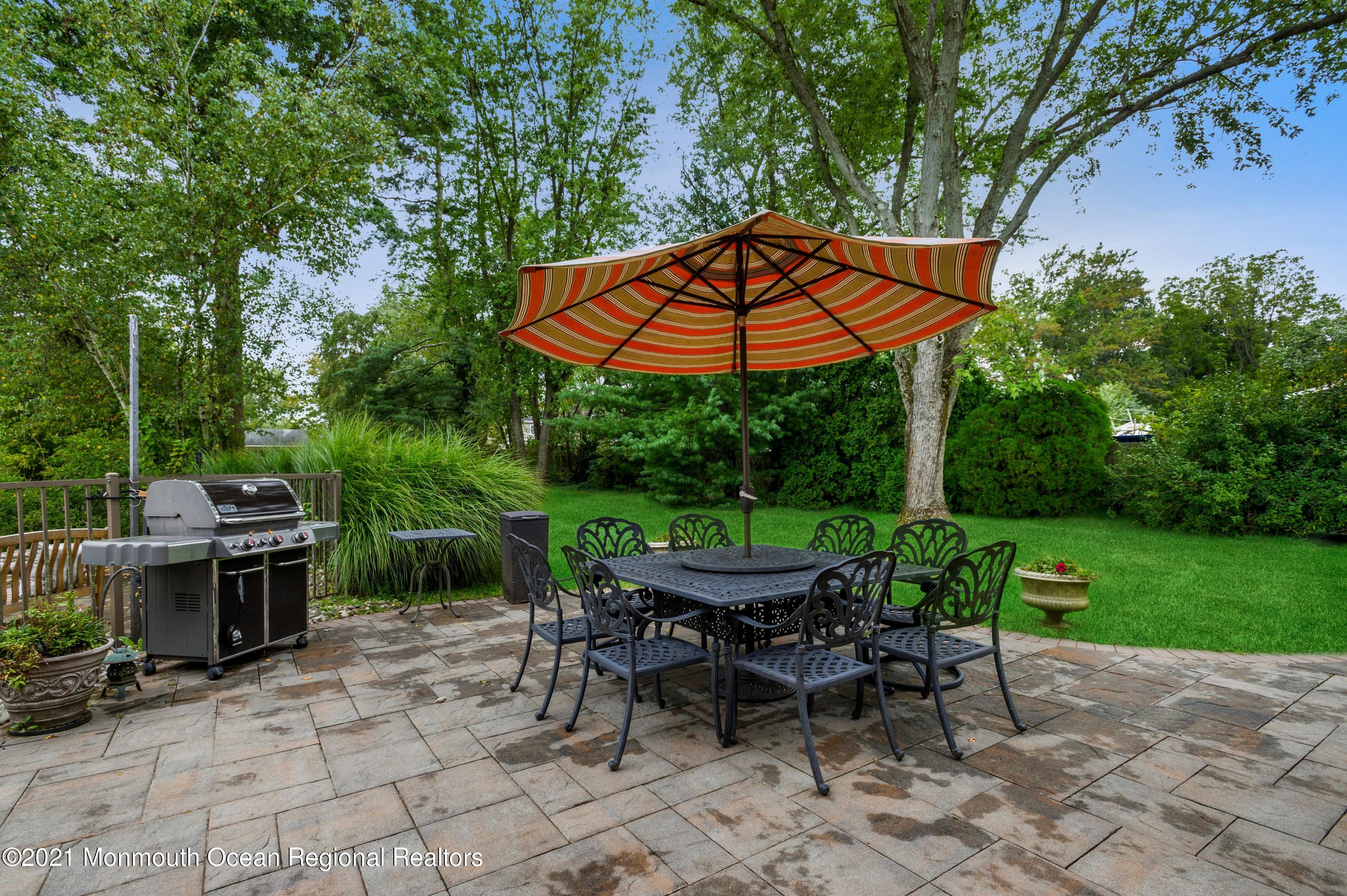 131 Bar Harbor Road Freehold, NJ 07728 - Photo 27 of 31 an outdoor space with furniture and umbrella