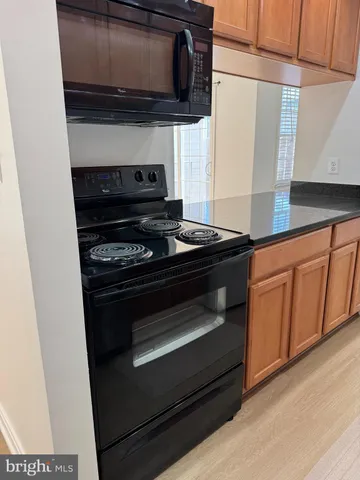 a kitchen with stainless steel appliances a stove and a microwave