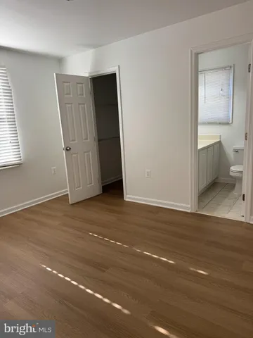 a view of a room with wooden floor and bathroom