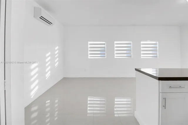 a view of an empty room with windows