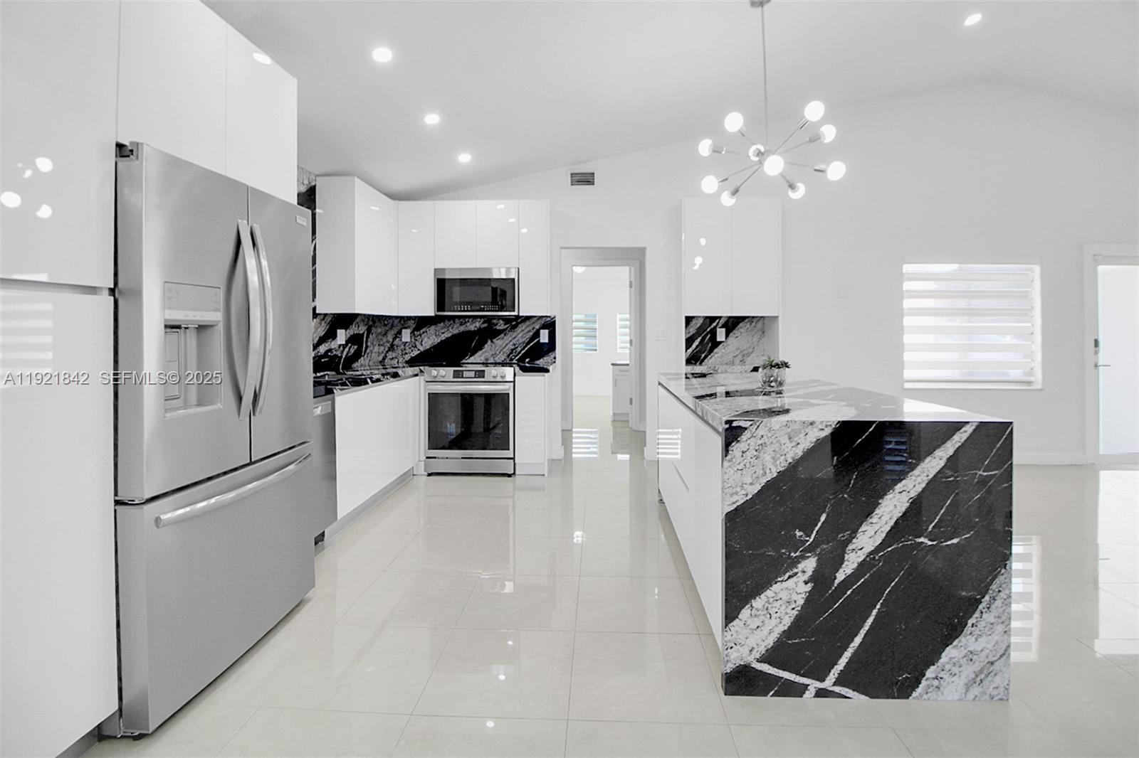 15251 Southwest 56th Terrace Miami, FL 33193 - Photo 2 of 29 a kitchen with kitchen island a counter top space stainless steel appliances and a window