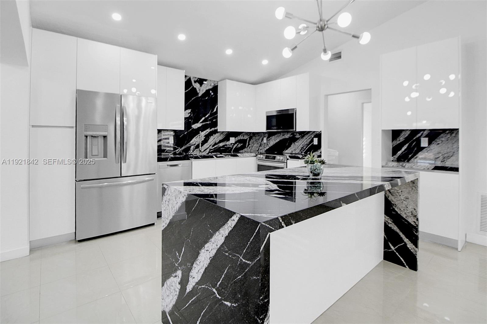15251 Southwest 56th Terrace Miami, FL 33193 - Photo 3 of 29 a kitchen with a sink stainless steel appliances and cabinets