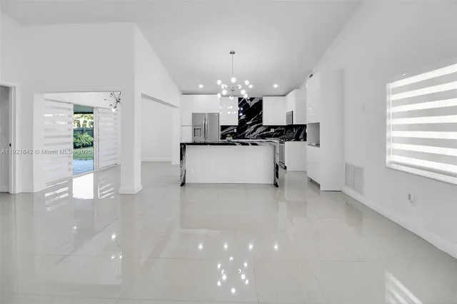 a view of a kitchen with a sink and a refrigerator