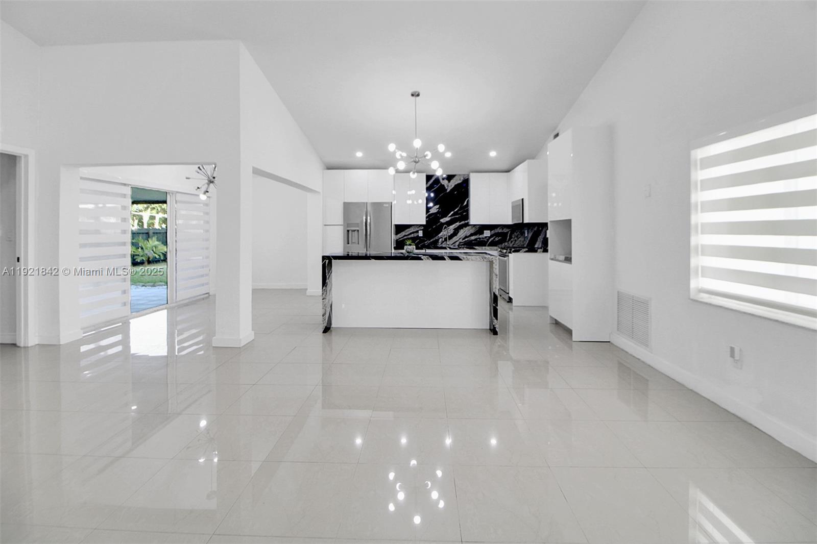 15251 Southwest 56th Terrace Miami, FL 33193 - Photo 4 of 29 a view of a kitchen with a sink and a refrigerator