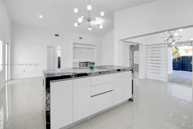 a kitchen with kitchen island a sink stainless steel appliances and cabinets